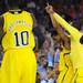 Michigan sophomore Trey Burke and fifth-year senior Corey Person hold their fingers in the air at they celebrate beating No.1 seed Kansas, 87-85 in overtime of their Sweet 16 match up at Cowboys Stadium in Arlington, Texas on March 29, 2013. Melanie Maxwell I AnnArbor.com